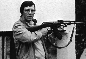 Peter Robinson with an automatic assault rifle