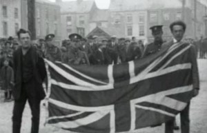 Two Irishmen forced to parade around Dungarvan by British troops with a British flag tied around their necks