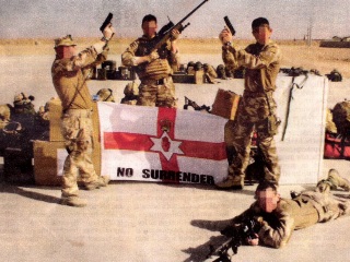 In Afghanistan soldiers of the RIR, a British Army unit, pose as UVF terrorists in front of an extremist flag