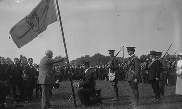 John Redmond MP presents a regimental flag to a unit of the Irish National Volunteers, the paramilitary wing of the Irish Parliamentary Party, the Phoenix Park, Dublin, Ireland, April 1915