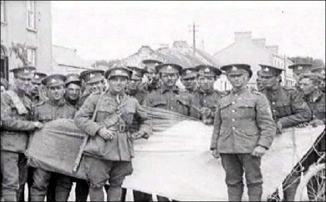 British troops pose with an Irish Tricolour captured from Pro-Treaty and Anti-Treaty Irish Republican Army units following the Battle of Pettigo and Belleek in late May and early June of 1922
