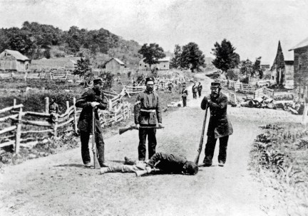 British militiamen stand over the body of a slain soldier of the Irish Republican Army following the Battle of Eccles Hill, the Second Fenian Invasion of Canada 1870
