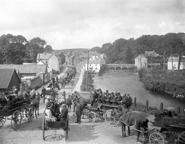 The main street of Pettigo, with the bridge into the village on the top right, c.1900