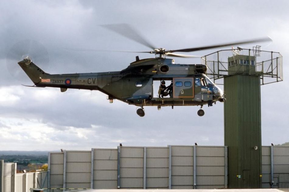 A British RAF Aérospatiale SA 330 Puma helicopter lands at a fortified UK base in the Occupied North of Ireland
