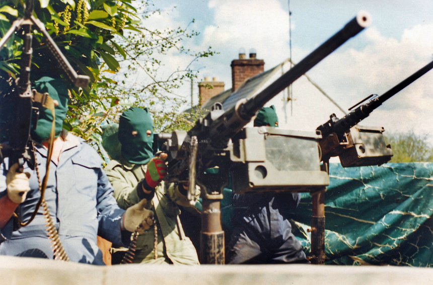 Three volunteers of the South Fermanagh Brigade, Irish Republican Army, stand in the back of an improvised armoured truck with American-supplied M2 Browning .50 Calibre heavy machine guns, February 1977